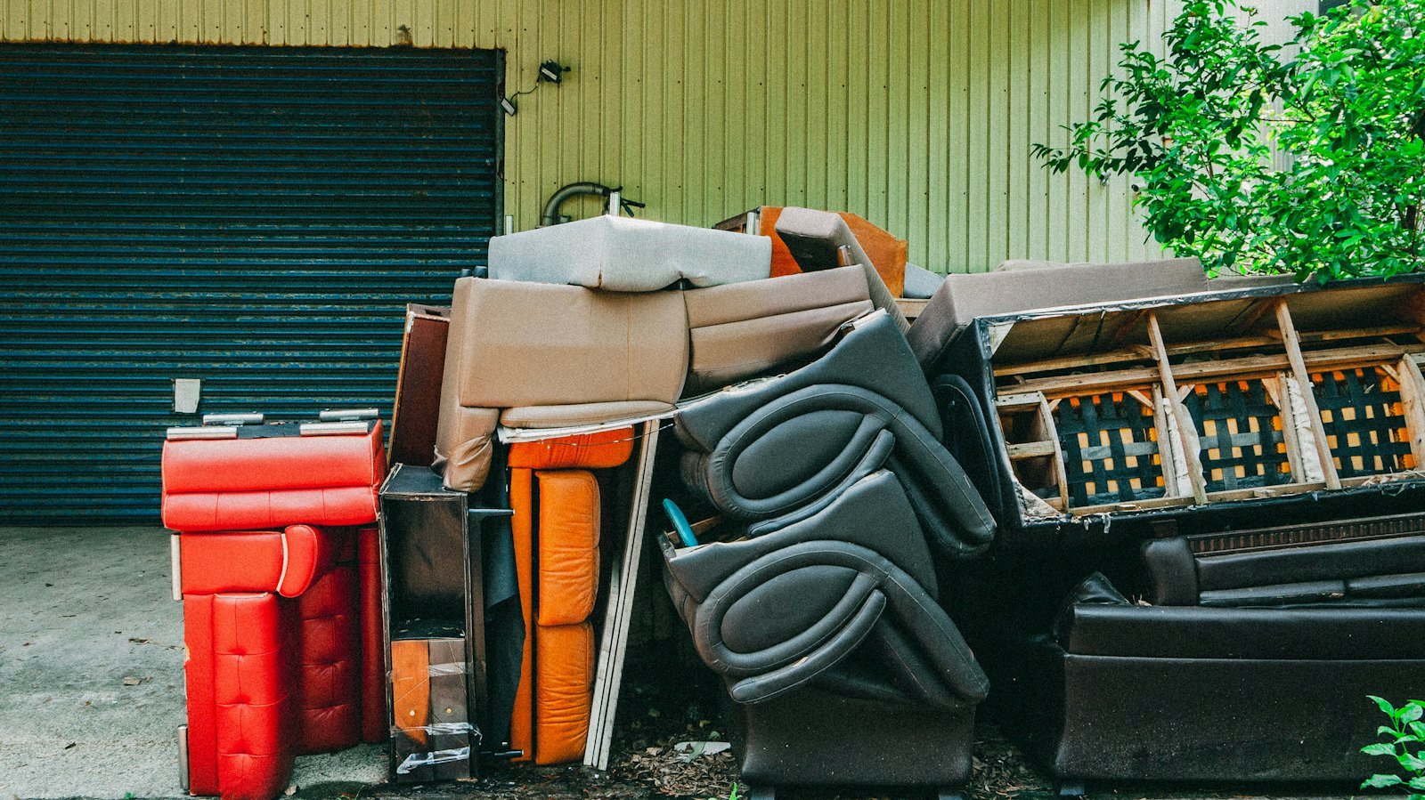 Household junk piled in front of a garage